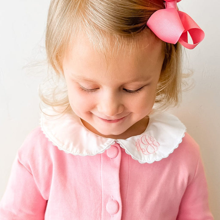 Girl in Peter Pan collar shirt with bow.