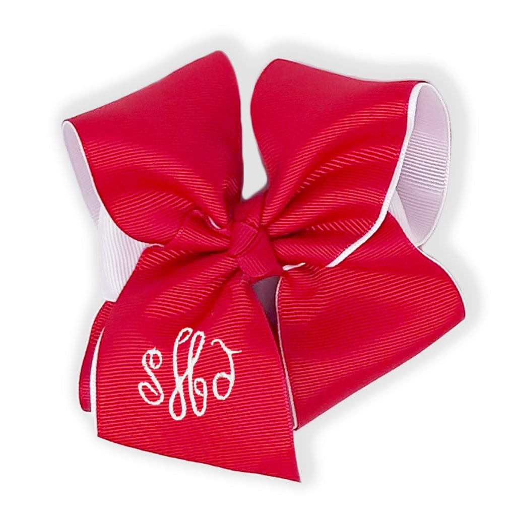 Red layered bow with white trim and monogram.