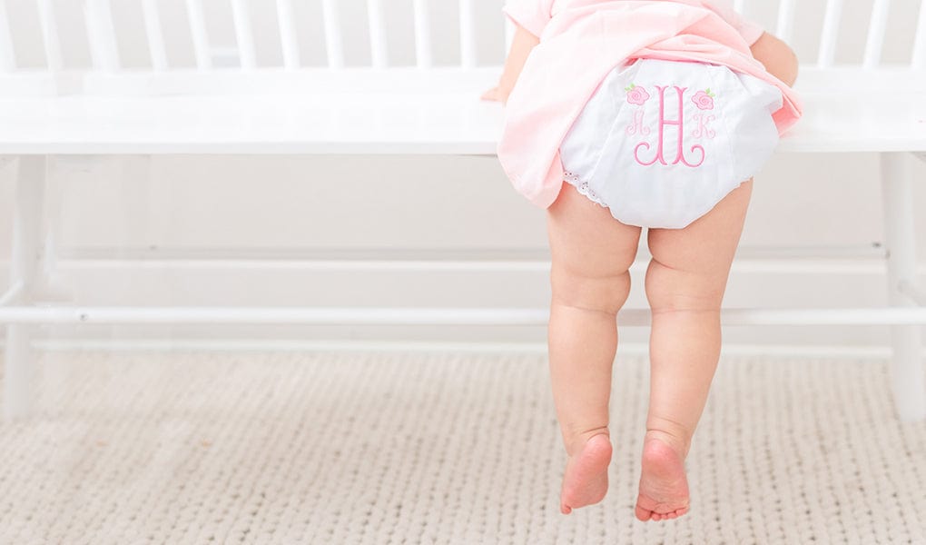 Rose bloomers with monogrammed H on baby girl.