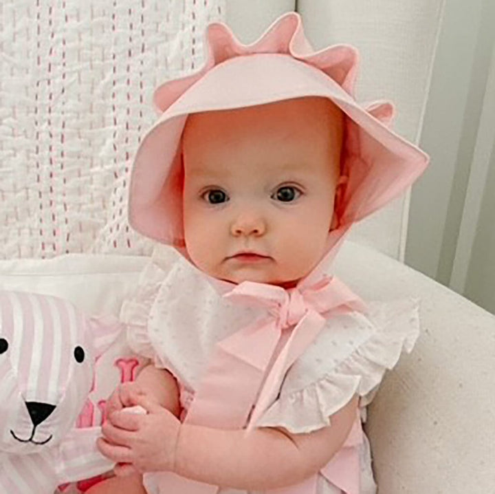Baby in pink bonnet