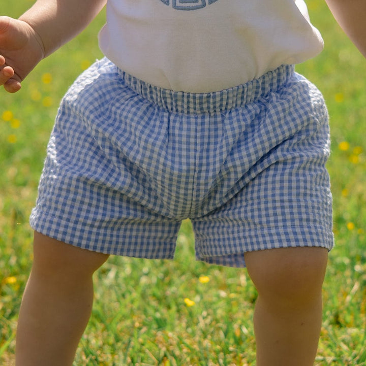 Baby in blue gingham shorts