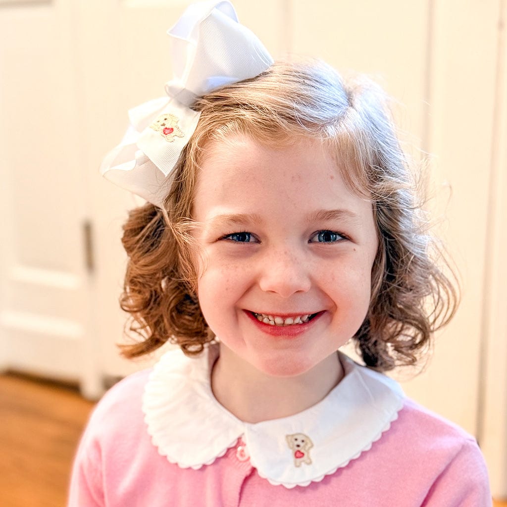 Monogrammed girls clothes, girl in a pink top with a peter pan collar