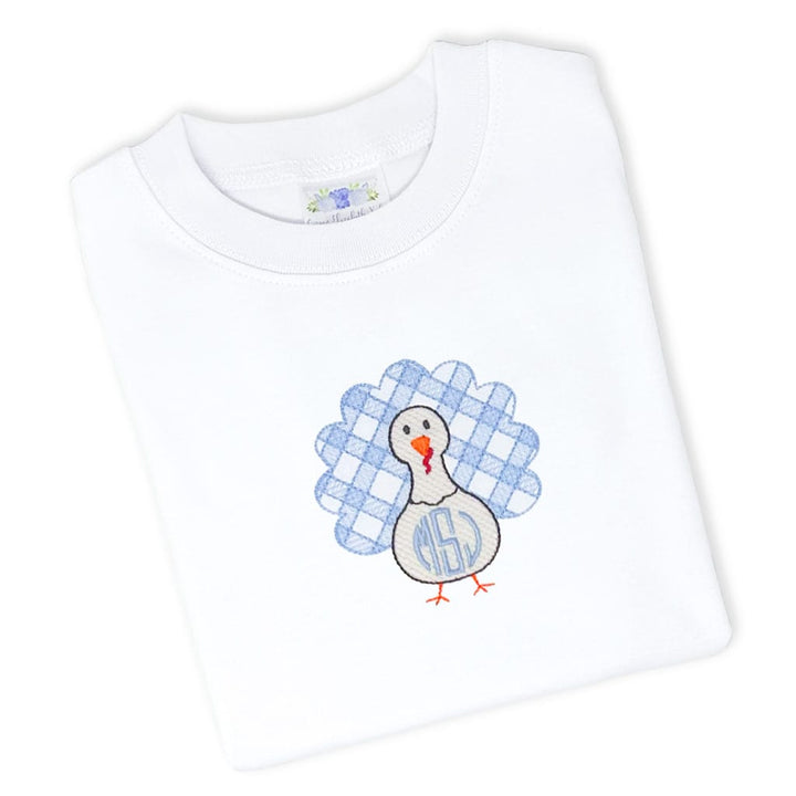 photo of a white turkey tee with a blue monogrammed turkey on the front
