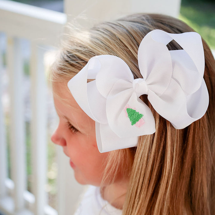 Embroidered holiday bow with monogram, ideal for pink Christmas outfits