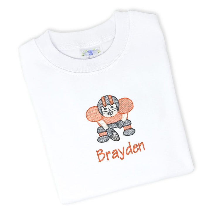 Boys tee with an embroidered football player design and name in team colors