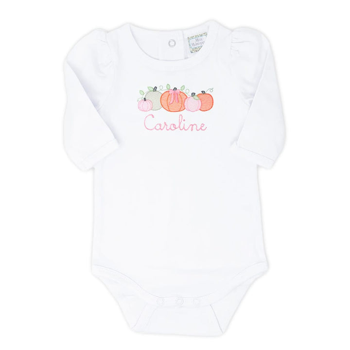 photo of a white pumpkin patch bodysuit with orange pumpkins and a name embroidered underneath