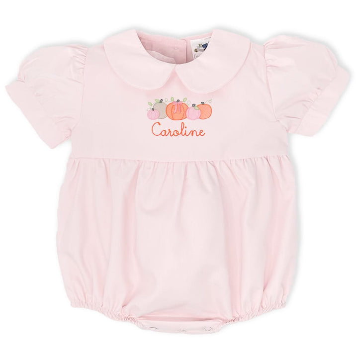 photo of a pink pumpkin patch bubble with a peter pan collar and orange pumpkins across the front