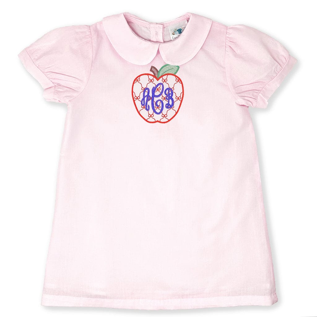 Pink dress with apple design and monogram on a white background