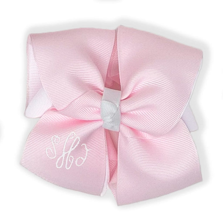 Pink layered bow with white knot and monogram.