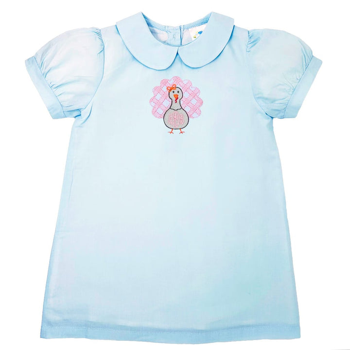 photo of a light blue turkey dress with a peter pan collar, puff sleeves and a pink turkey on the front