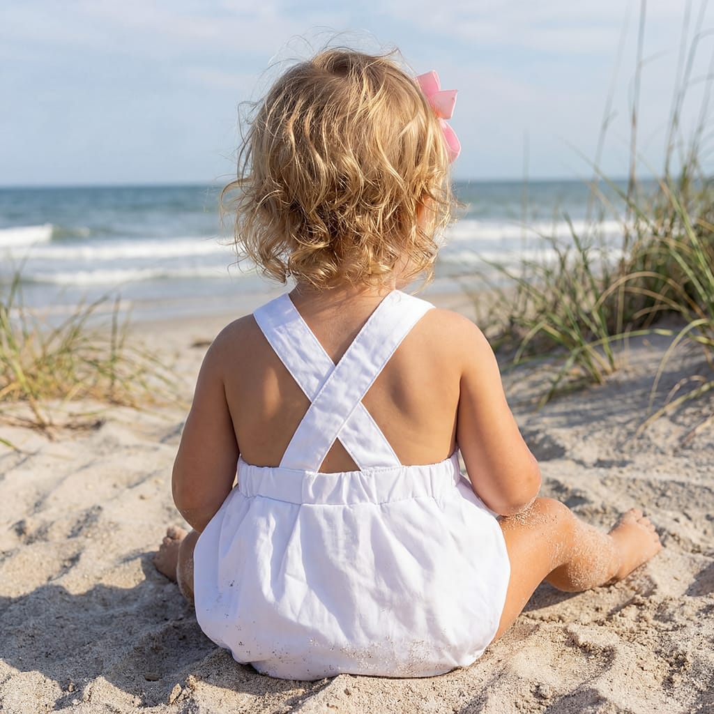 Girls White Sunsuit with straps that cross in the back