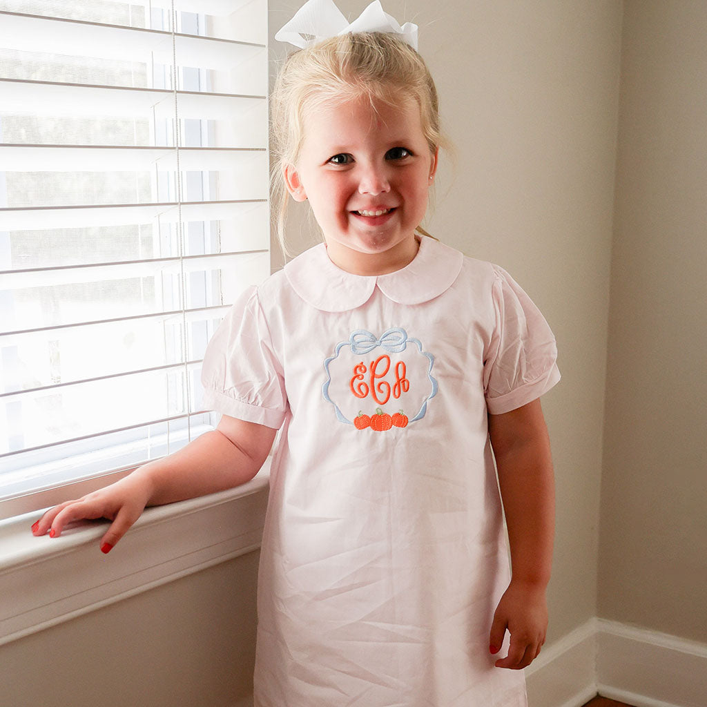 girl's pink dress with classic pumpkin trio embroidery and monogram for autumn